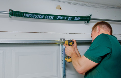 Technician Repairing Garage Door